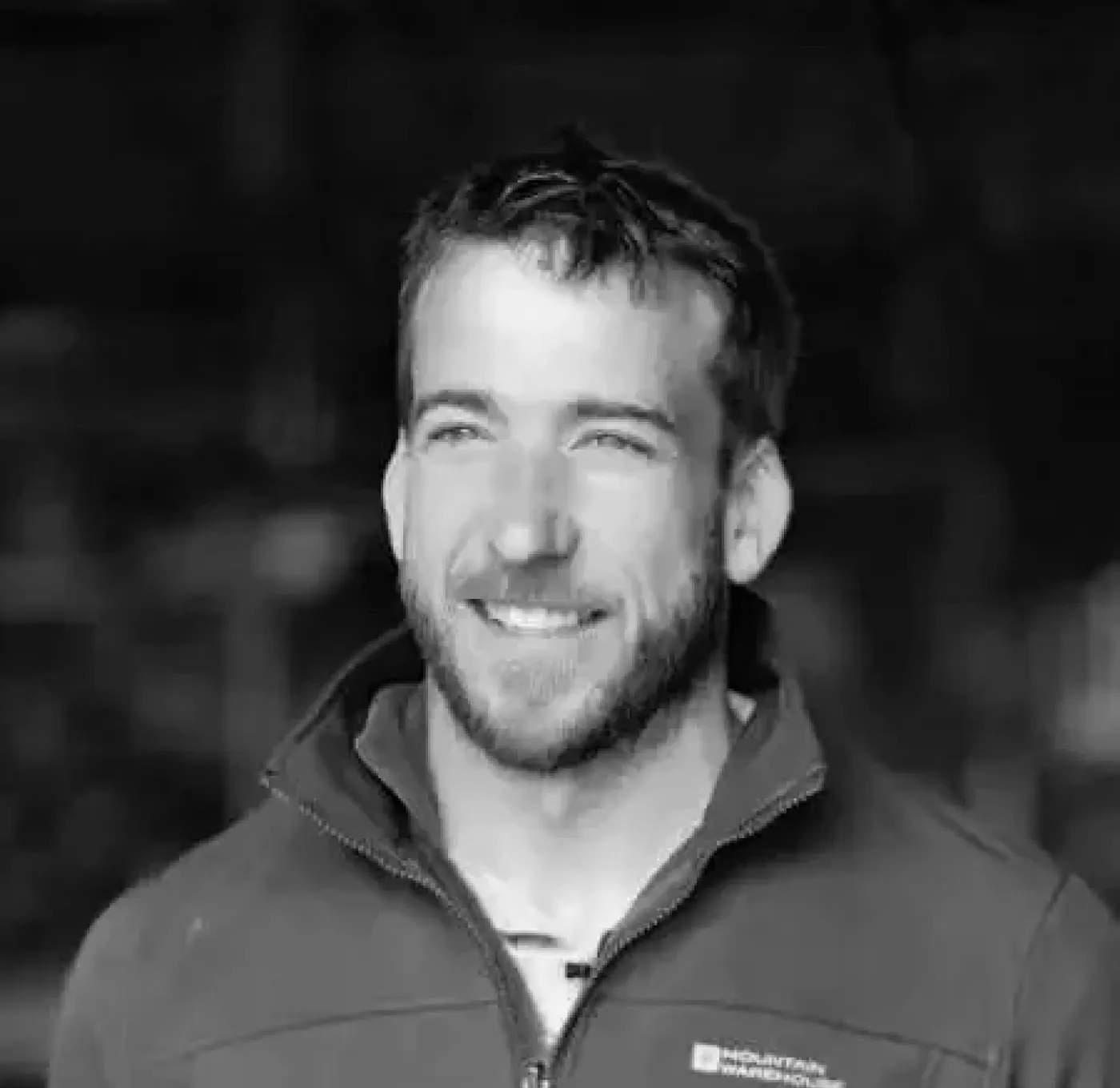 Profile-style portrait photograph of a person against a simple background.